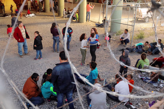 Image: Migrants from Central America wait inside of an enclosure, where they are being held by U.S. Customs and Border Protection (CBP), after crossing the border between Mexico and the United States illegally and turning themselves in to request asylum,