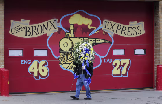 Image: A man brings flowers to a firehouse in memory of firefighter Christopher Slutman in the Bronx, New York, on April 9, 2019. Slutman was killed by a roadside bomb in Afghanistan on April 8.