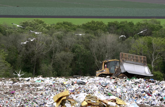 A bulldozer shifts garbage at the Monterey Regional Waste Management District landfill on Earth Day