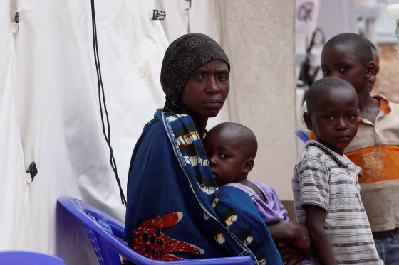 Image: A Congolese woman and her children who are suspected Ebola patients sit at the Ebola treatment centre in Butembo