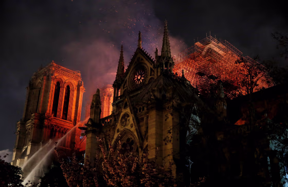 Image: Firefighters continue to extinguish flames at the Notre Dame Cathedral in Paris on April 15, 2019.