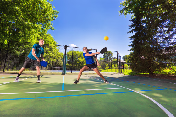 Image: Young Man and Woman Playing Pickleball in Court