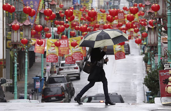 Image: Woman carries umbrella in San Franisco, Chinatown