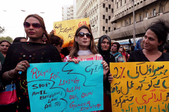 Image: Members of the transgender community hold signs against the anti-begging law for the transgender community, during a protest demanding jobs in Karachi