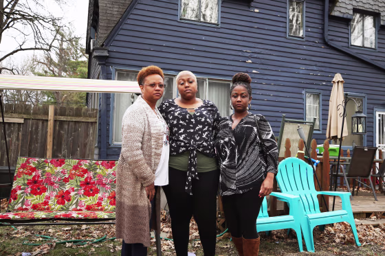 Monique, Ashley Gunn and Alicia stand outside Ashley's house