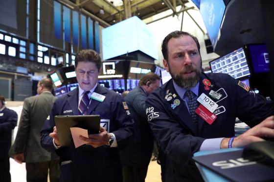 Image: Traders work on the floor at the NYSE in New York