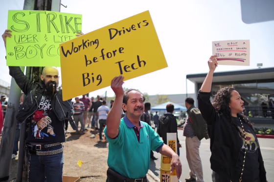 Striking Uber and Lyft drivers protest Uber's decision to cut per-mile pay from 80 cents to 60 cents, outside the Uber Hub in Redondo Beach