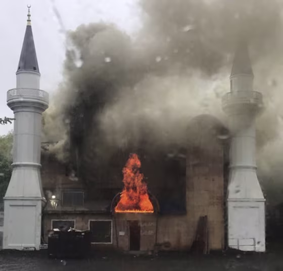 In this photo provided by Lina Biroscak, a fire burns at a mosque Sunday in New Haven, Conn.