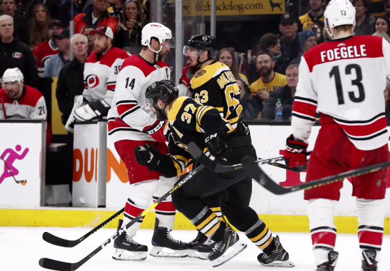 BO Carolina Hurricanes right wing Justin Williams and Boston Bruins left wing Brad Marchand face off