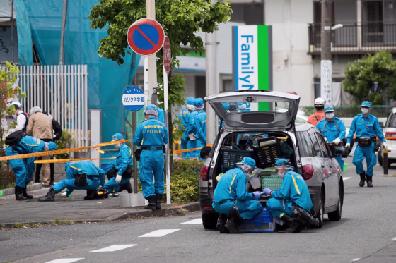 Image: Police forensic experts work at the crime scene where a man stabbed 19 people, including children in Kawasaki