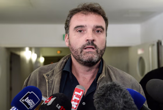 Image: Frederic Pechier, an anaesthetist suspected of poisoning and murder at the Besancon hospital, talks to journalists as he leaves the court after his hearing in Besancon