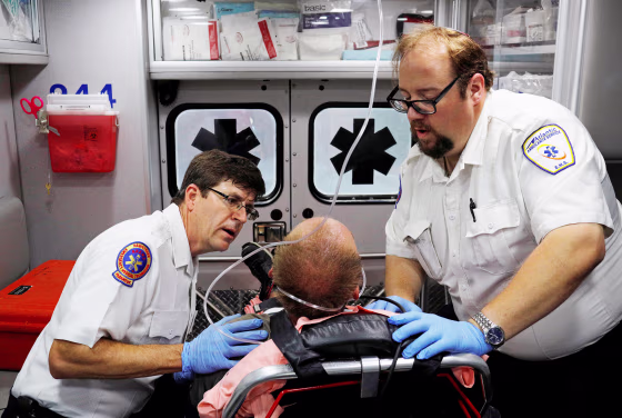 Cataldo Ambulance medics John Gardner and David Farmer care for a man in his 40's who was found unresponsive after overdosing on an opioid in the Boston suburb of Salem