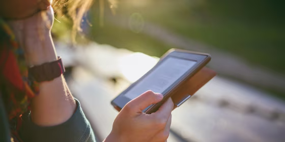 Close-Up Of Woman Reading Ebook