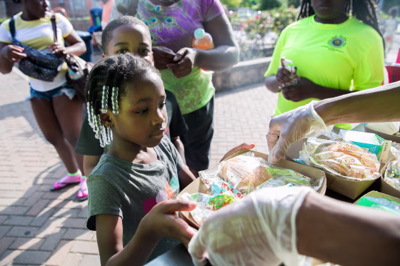 Children wait to receive a free meal at Rowley Park in East Orange.
