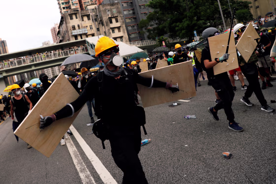Demonstrators march to protest against the Yuen Long attacks