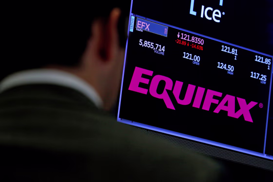 Trading information and the company logo are displayed on a screen where the stock is traded on the floor of the NYSE in New York