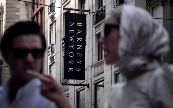 Image: Pedestrians cross the street near the Barneys department store in New York on July 16, 2019.