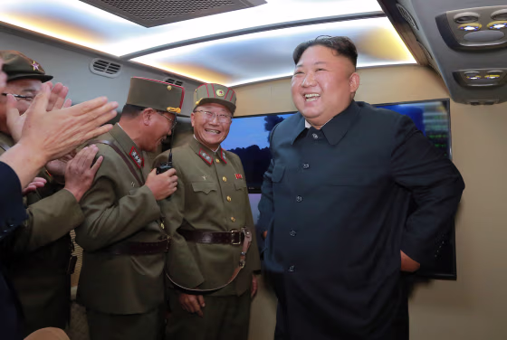 Image: North Korean leader Kim Jong Un smiles as he guides missile testing at an unidentified location in North Korea