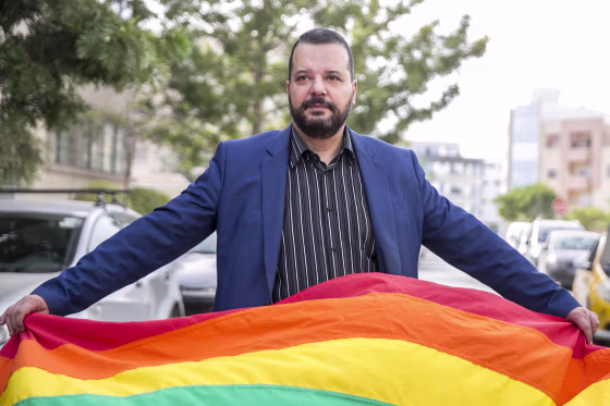 LGBT activist Mounir Baatour holds a rainbow flag after submitting his candidacy for the upcoming early presidential elections in Tunis, Tunisia on Aug. 8, 2019.
