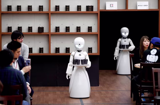 Image: FILE PHOTO: Remotely controlled robots OriHime-D serve customers at a cafe in Tokyo