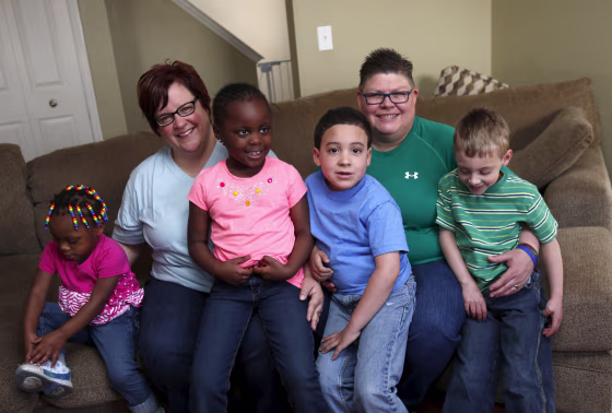 Image: Michigan couple DeBoer and Rowse pose with their children in their home in Hazel Park