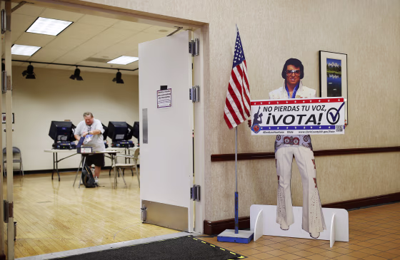 A sign with an Elvis impersonator reminds people to vote at an early primary election polling site in Las Vegas on May 31, 2016.