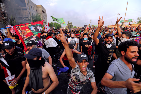 Image: Demonstrators gesture at a protest over unemployment, corruption and poor public services, in Baghdad