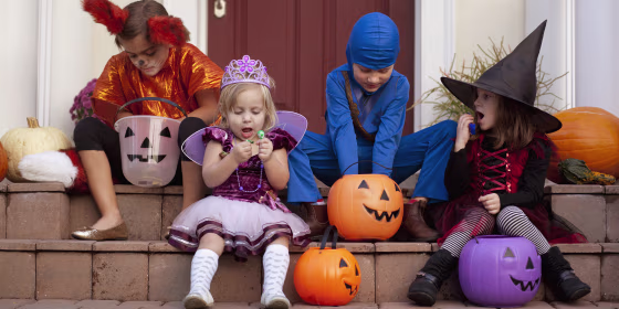 Children enjoying treats on steps