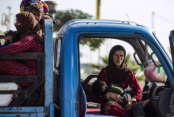 Image: Syrian families fleeing the battle zone between Turkey-led forces and Kurdish fighters from the Syrian Democratic Forces (SDF) in and around the northern flashpoint town of Ras al-Ain, arrive in the city of Tal Tamr