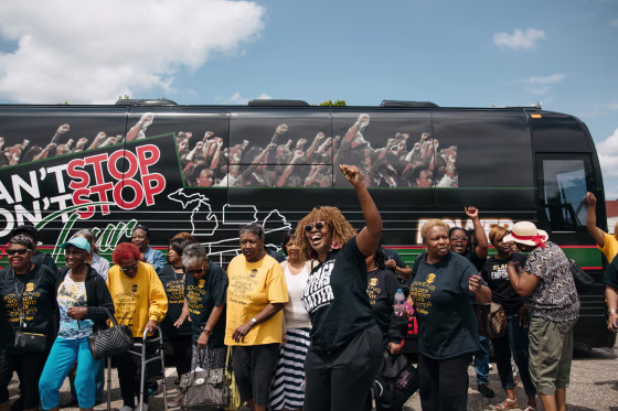 LaTosha Brown cheers with Pontiac residents outside of the Bowen Senior Center.