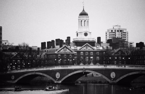 Image: Rowers sail down the Charles River past Harvard University in Cambridge, Mass., in 2017.
