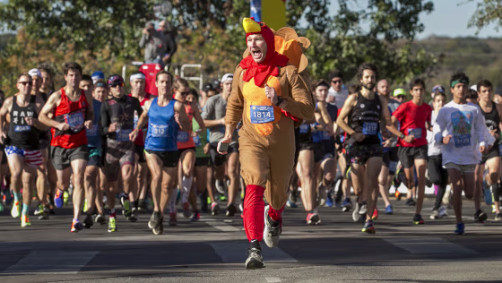 Chris Conlan leads the runners at the start of the 27th annual ThunderCloud Subs Turkey Trot in downtown Austin, Texas, on Nov. 23, 2017.