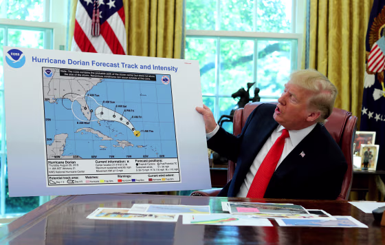 Image: UPresident Donald Trump holds an early projection map of Hurricane Dorian in the Oval Office on Sept. 4, 2019.