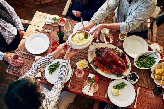 Image: Cropped shot mash being passed during a feast at a dining table