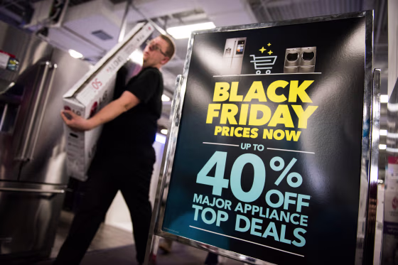 Image: An advertisement for Black Friday sales on appliances stands on display at a Best Buy Inc. store in Paramus, New Jersey.