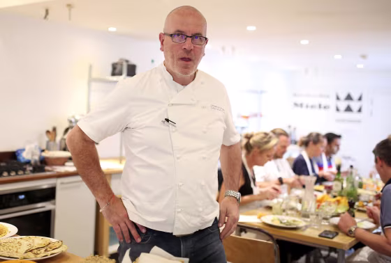 Image: French Chef Richard Bertinet alongside pupils and staff at his cookery school in Bath, Somerset, United Kingdom