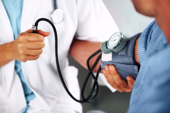 A doctor listening to his patient's heartbeat with a stethoscope