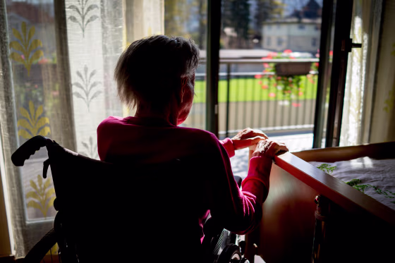 Senior woman in wheelchair at home