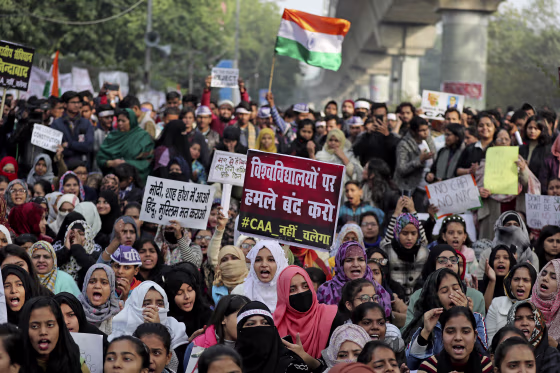 Indian students of the Jamia Millia Islamia University and locals participate in a protest demonstration against a new citizenship law in New Delhi, India, Saturday. Critics say the law violates India's secular constitution and call it the latest effort by the Narendra Modi government to marginalize the country's 200 million Muslims. Modi has defended the law as a humanitarian gesture. Placard center reads "Stop attacking universities."