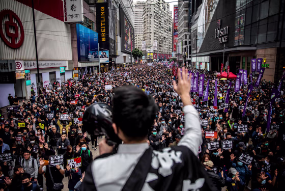 Image: Tens of thousands of protesters march in a New Years Day protest in Hong Kong.