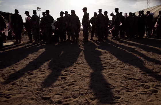 Image: Soldiers wait to pack their weapons at Camp Virginia in Kuwait after departing Iraq to return to the United States on Dec. 19, 2011.