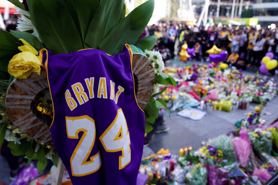 Image: Fans of NBA basketball star Kobe Bryant pay their respects at a memorial outside the Staples Center at L.A. Live in Los Angeles