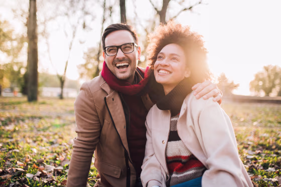 Smiling couple sitting in the park