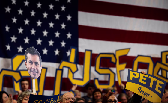Image: Supporters hold signs at a town hall event for Pete Buttigieg in Coralville, Iowa, on Feb. 2, 2020.