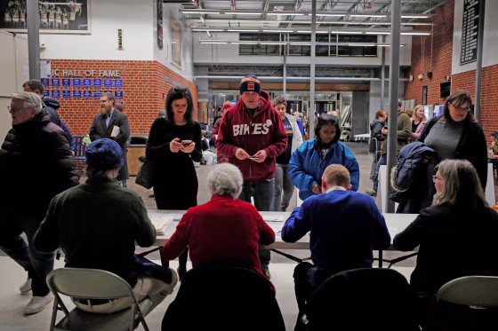 Iowans register at their caucus site in Des Moines on Feb. 3, 2020.