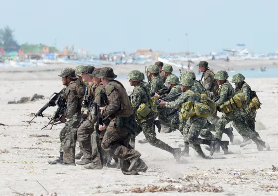 Image: Philippine and U.S. Marines taking positions during a beach assault exercise facing the South China Sea in San Antonio, Zambales province.