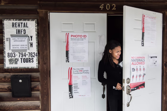 Image: A poll worker peeks out the door at American Legion Memorial Cayce Post 130