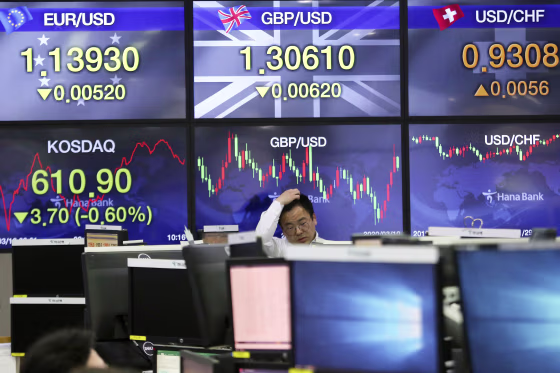 Image: A currency trader watches monitors at the foreign exchange dealing room of the KEB Hana Bank headquarters in Seoul, South Korea