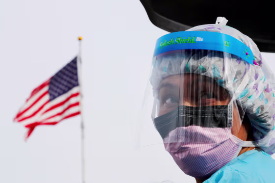 Image: A nurse wears protective gear at a drive-thru coronavirus testing site in Seattle on March 17, 2020.