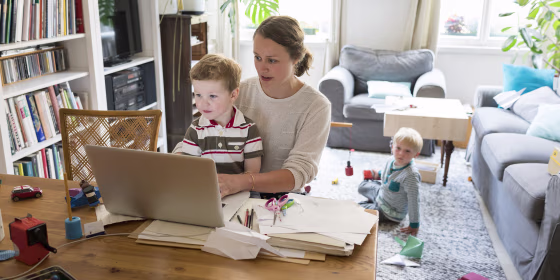 Female professional with two sons working at home